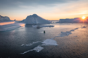 Barco navegando entre icebergs desde punto de vista aereo