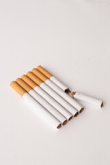 blonde cigarettes with filter on a white table, white background