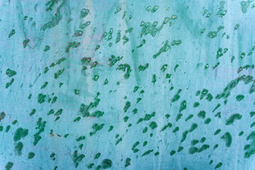 Turquoise blue aged weathered metal surface door with green rain water drops background texture
