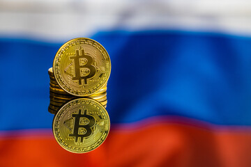 Bitcoin in front of russian flag. Digital cryptocurrency. Russian flag background.