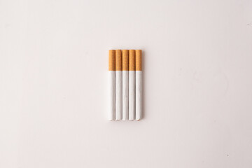 blonde cigarettes with filter on a white table, white background
