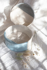 Fototapeta na wymiar handmade ceramic vessels made by hand on a white cloth