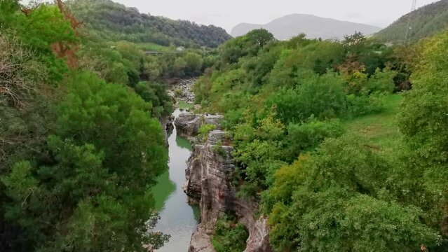 people practicing canyoning with kayaks in the Marche region at "Marmitte dei giganti", Italy