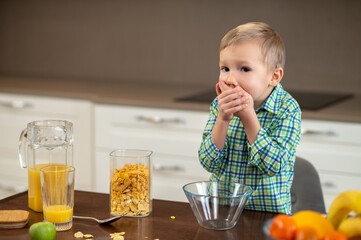 Little Caucasian boy refusing to have breakfast