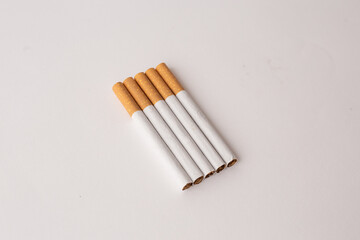 blonde cigarettes with filter on a white table, white background