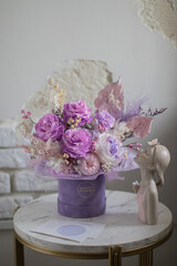 A mix of pink peonies with purple and pink roses on coffee table. Bouquet of tenders peonies a girl for mother's day, valentine's day, Woman's day 8 march.