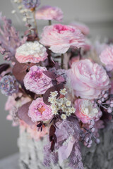Flowers arrangement with roses in bark pot in vintage.