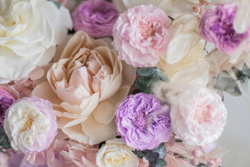 A luxurious bouquet of flowers in a hat box. Composition with pink and white flowers and eucalyptus in a round box. Modern Floristry.