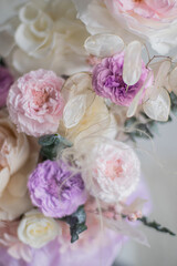 A luxurious bouquet of flowers in a hat box. Composition with pink and white flowers and eucalyptus in a round box. Modern Floristry.