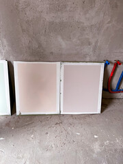 Boards with color samples in a room with concrete walls