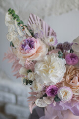 A luxurious bouquet of flowers in a hat box. Composition with pink and white flowers and eucalyptus in a round box. Modern Floristry.