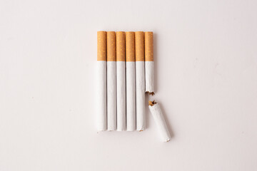 blonde cigarettes with filter on a white table, white background