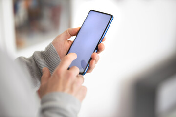 Male hands typing on smartphone