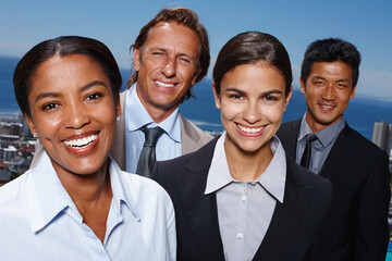 Taking on business with a smile. Portrait of a group of businesspeople standing outside on a patio overlooking the ocean.