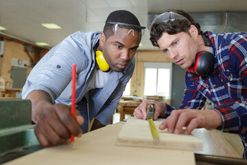 carpenter with apprentice in training period