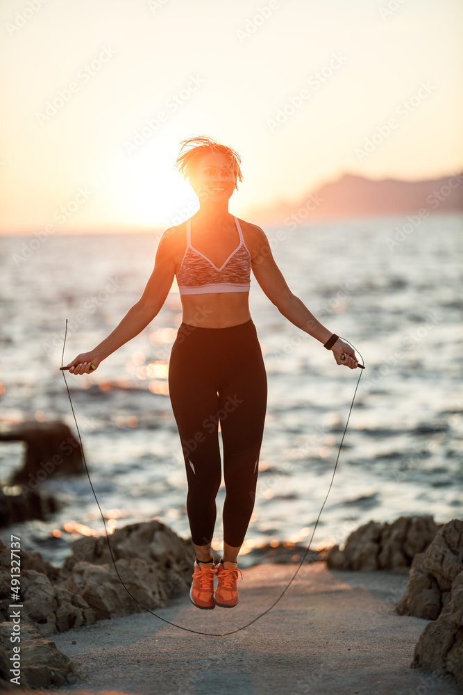 Sticker Woman Jumping Rope While Working Up Outdoors Training Near The Sea