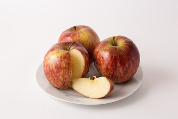 Naklejka na ściany i meble ripe red apples on a plate, white background