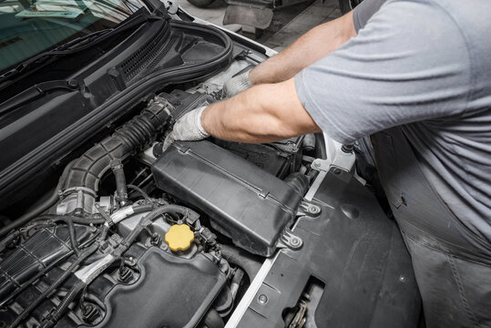Mechanic repairing engine on a car using wrench. Close up of hands