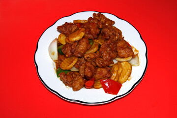 Jakarta Chicken Chinese, Indonesian food on a red tablecloth background. Close up.