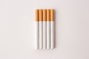 blonde cigarettes with filter on a white table, white background