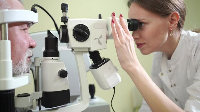 ophthalmologist examination of elderly man with slit lamp. medical equipment