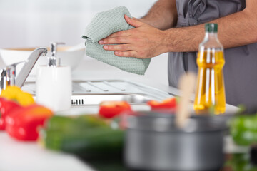 young man cleaning dishes in the kitchen