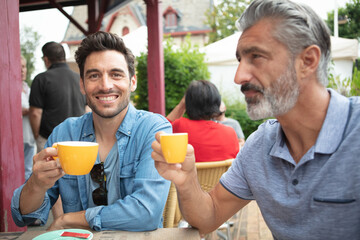 two friends sitting at desk and discussing ideas
