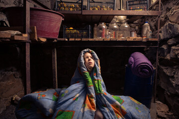 Ukrainian kid takes shelter in her basement.