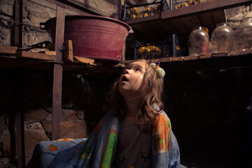 Ukrainian kid takes shelter in her basement.