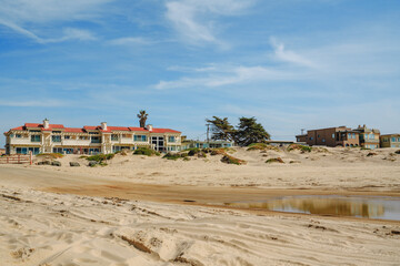 Wide sandy beach and hotels with ocean view in small beach town. Oceano, California Central Coast