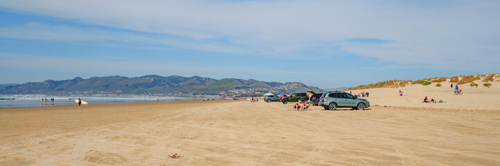 Fototapeta premium Cars on the beach. Oceano Dunes, California Central Coast, the only California State Park that allows vehicles to drive on the beach
