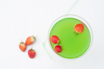Colorful bright green cocktail cactus with strawberries, delicious refreshing