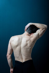 Back view of faceless muscular shirtless acrobat male.