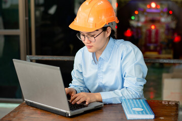 Asian female engineer working on laptop