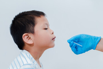 A nurse is using an initial virus test kit for her son, the Antigen Test Kit, or ATK, as a test kit...