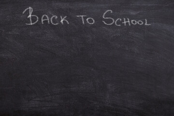 Back to School sign written on blackboard chlak font