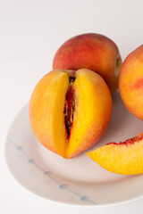 ripe peaches on a plate, white background