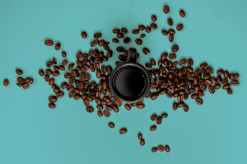 coffee beans and espresso mug on a blue background