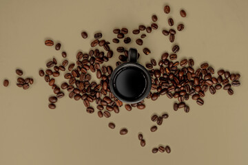 coffee beans and espresso mug on a brawn background