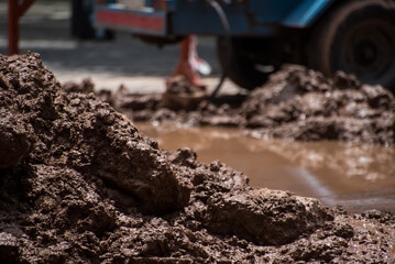 asphalt under repair with water and mud