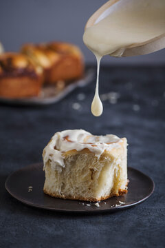 Cinnamon bun with icing on plate