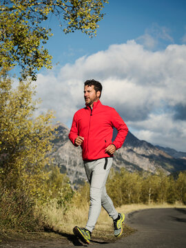 United States, Utah, American Fork, Man jogging on mountain road on sunny day