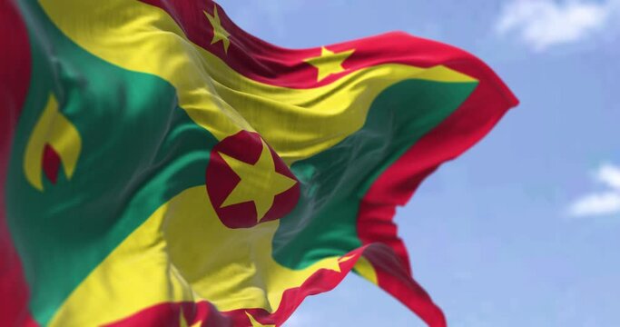Detail of the national flag of Grenada waving in the wind on a clear day