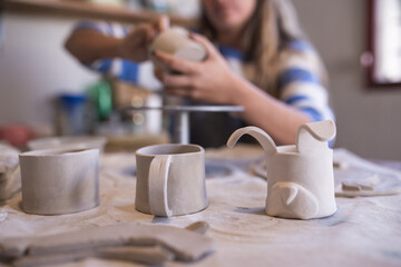 woman making ceramic handicrafts on a table