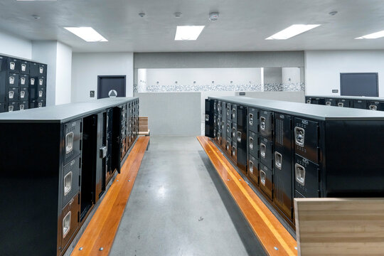 Locker room interior with lockers, benches, aisle