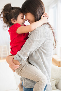 Hispanic mother and daughter hugging