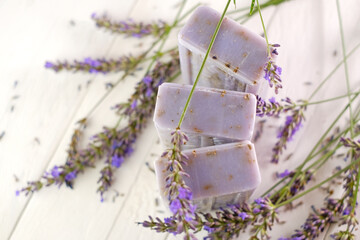 Lavender soap. purple soap bars and lavender branches on a white shabby chic background.lavender scent.Beauty and aromatherapy.