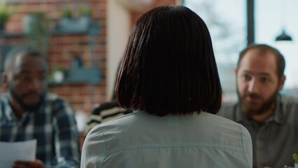 Back view of african american candidate attending job interview with team of HR employees in office. Applicant and workers meeting to discuss about company recruitment, career offer.
