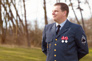 Serving his country. Shot of a high ranking military officer standing at ease in the outdoors.