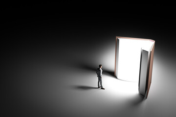 3D illustration young businessman standing in front of a large book. 3D rendering © nonnie192